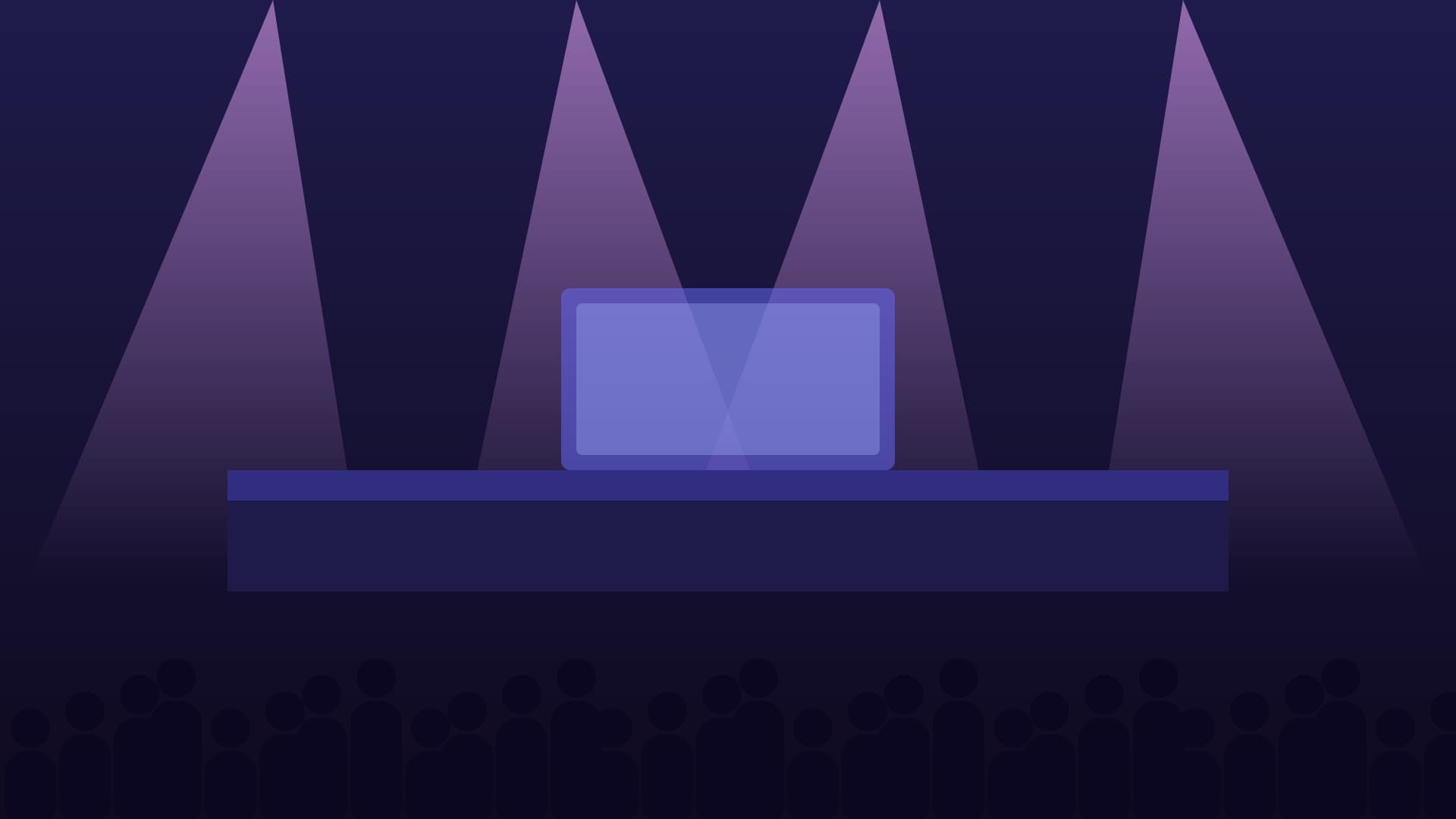 A stage lit by spotlights in front of an audience